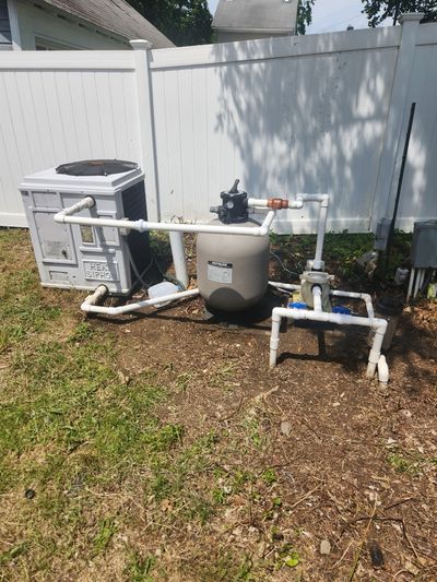 Outdoor pool equipment plumbing — heater and filter manifold.